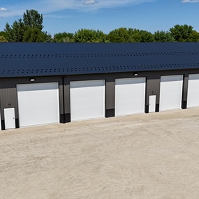 New commercial garage door installation across multi-bay storage building in Eldorado, WI