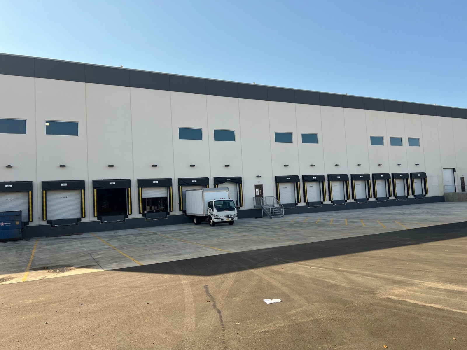 Modern farmhouse home with dark garage doors