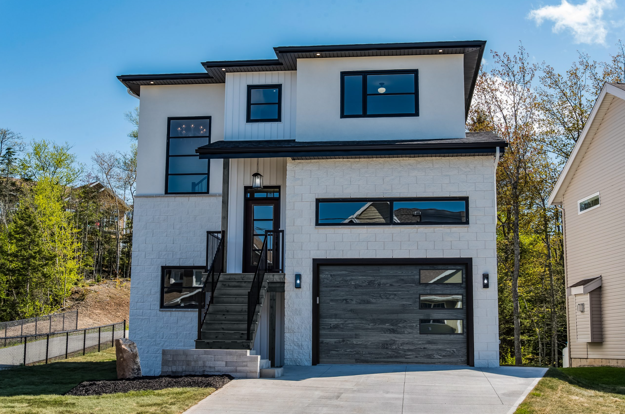 Modern home with dark garage doors