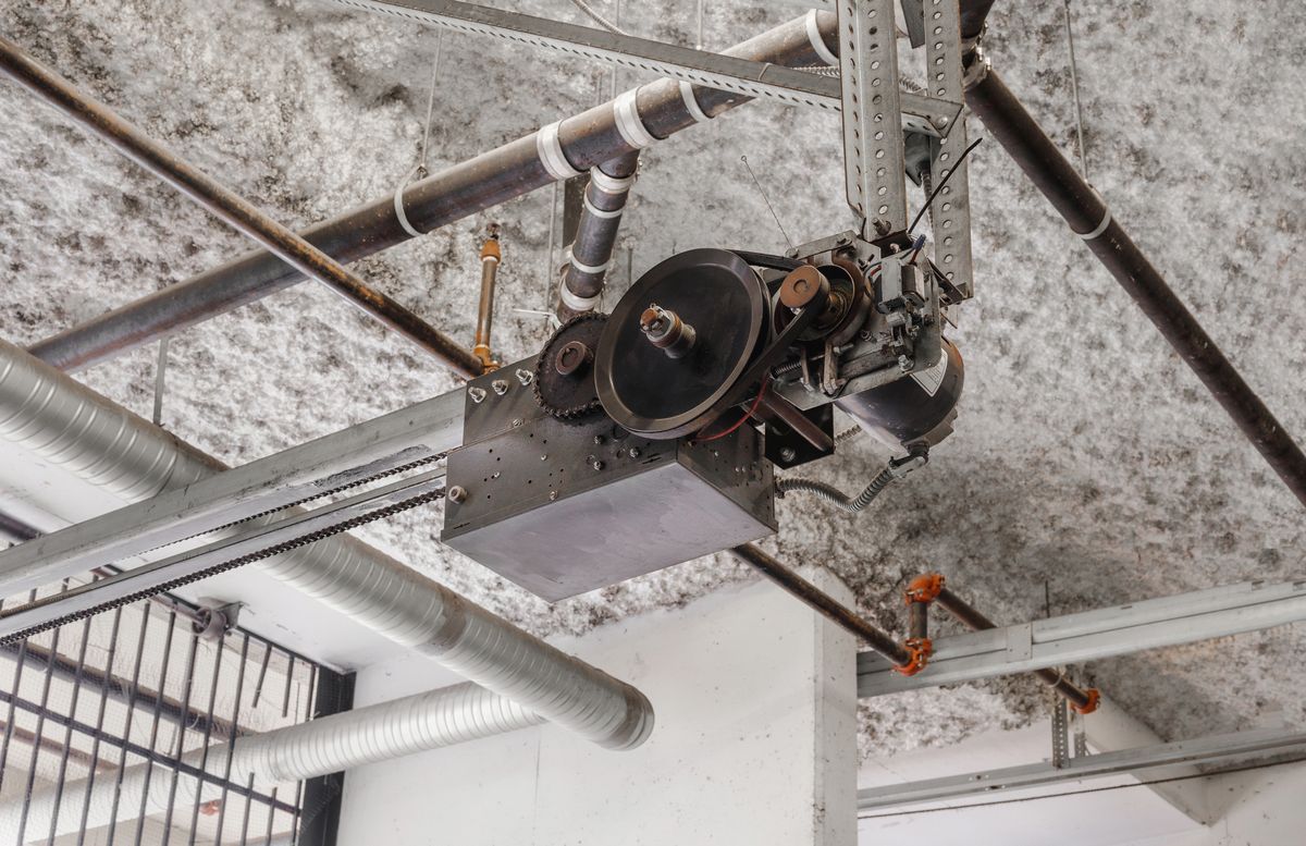 Modern farmhouse home with dark garage doors