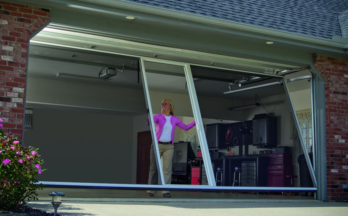 Modern farmhouse home with dark garage doors